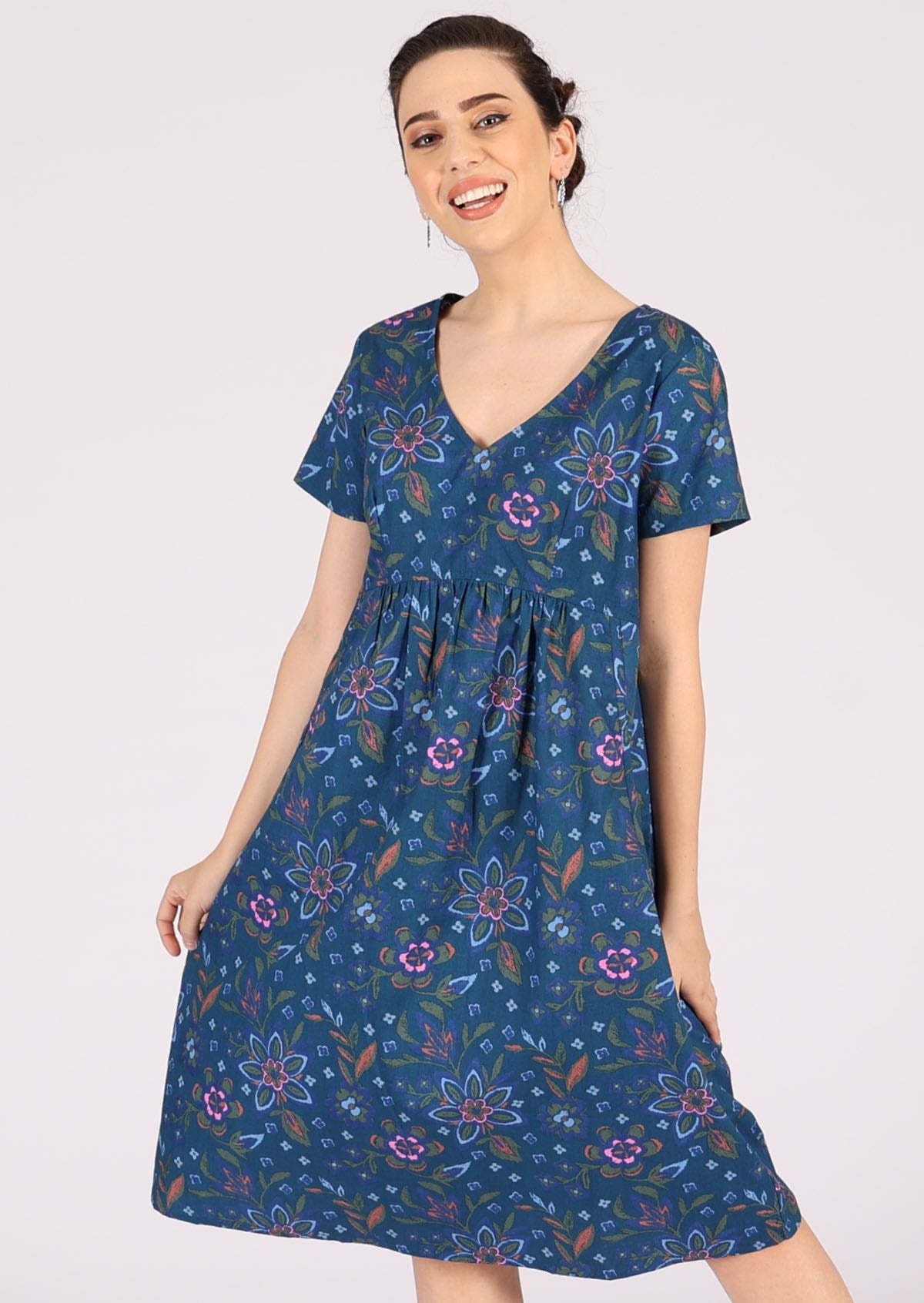 Blue based dress has a green, orange and pink floral print. 