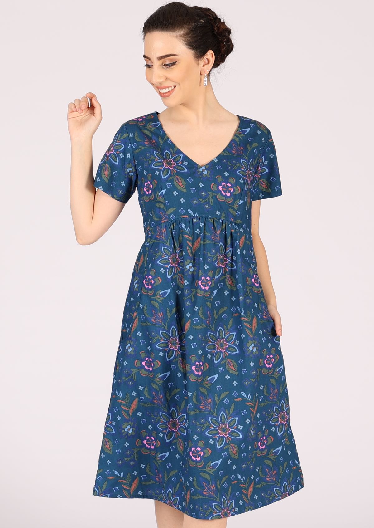 Model wears 100% cotton short sleeve dress in blue. 