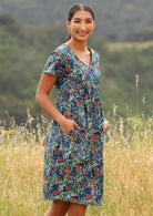 Smiling model wear 100% cotton dress with pockets. 