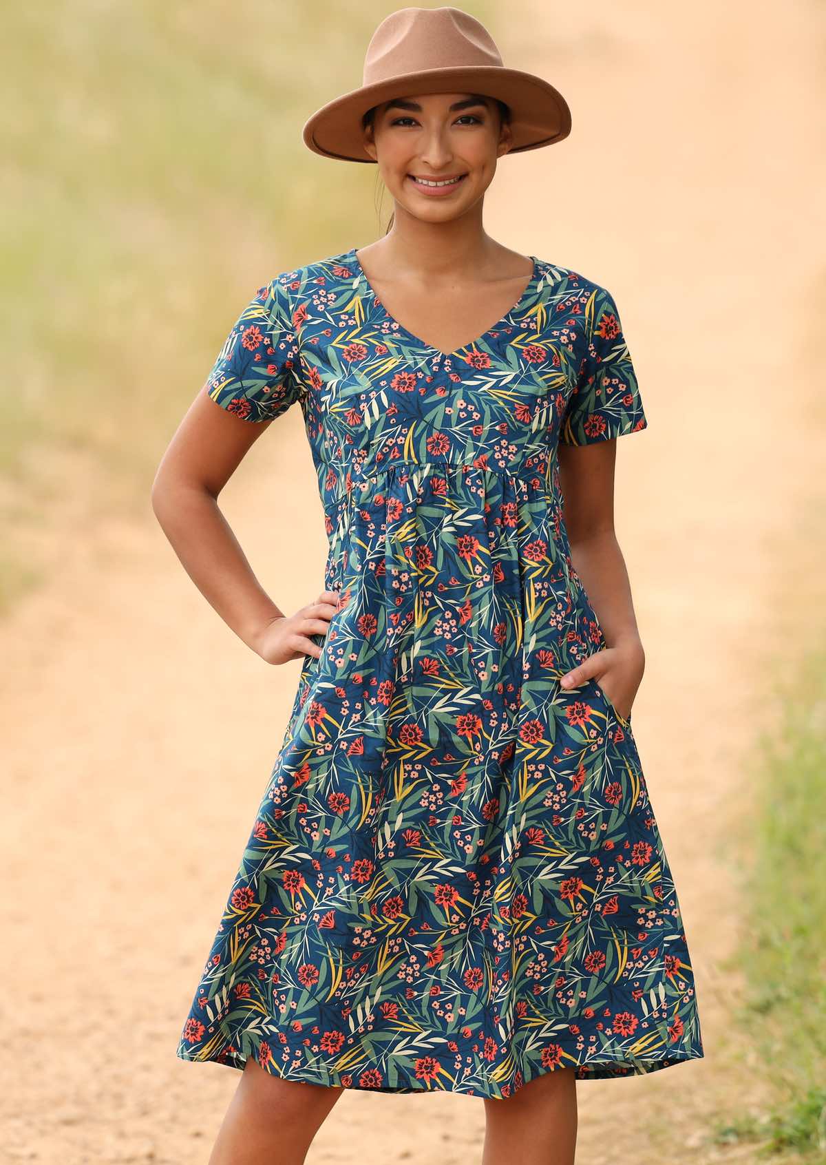 Model styles cotton dress with a hat. 