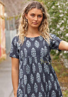 Woman in lane way with navy blue cotton Indian print summer dress 