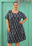 Size 18 model wearing navy blue cotton dress with Indian print and lining