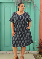plus sized model wearing navy blue cotton dress with Indian print and lining