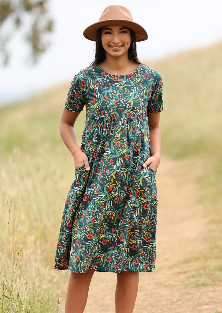 Model wears knee length dress with a round neckline. 