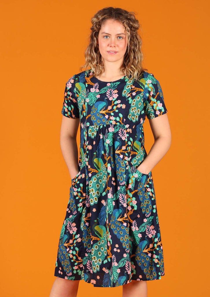 Woman wearing Frankie Dress Peacock 100% cotton lightweight lined relaxed fit knee length dress with pin tucks and pockets 