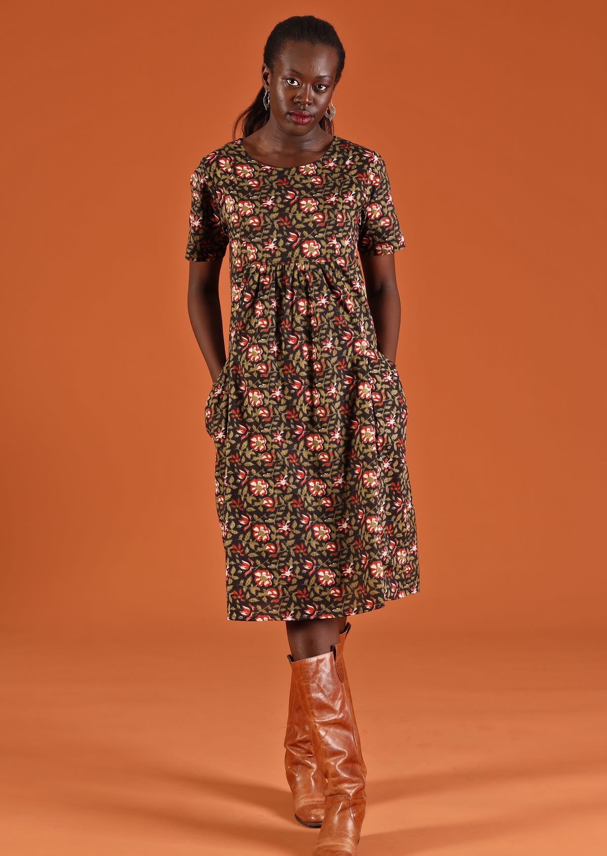 A model is wearing a 100% cotton floral dress