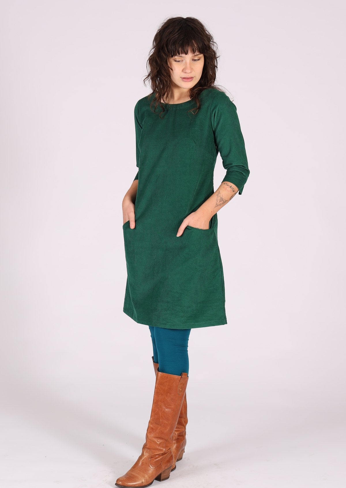 Green corduroy dress with pockets at the front