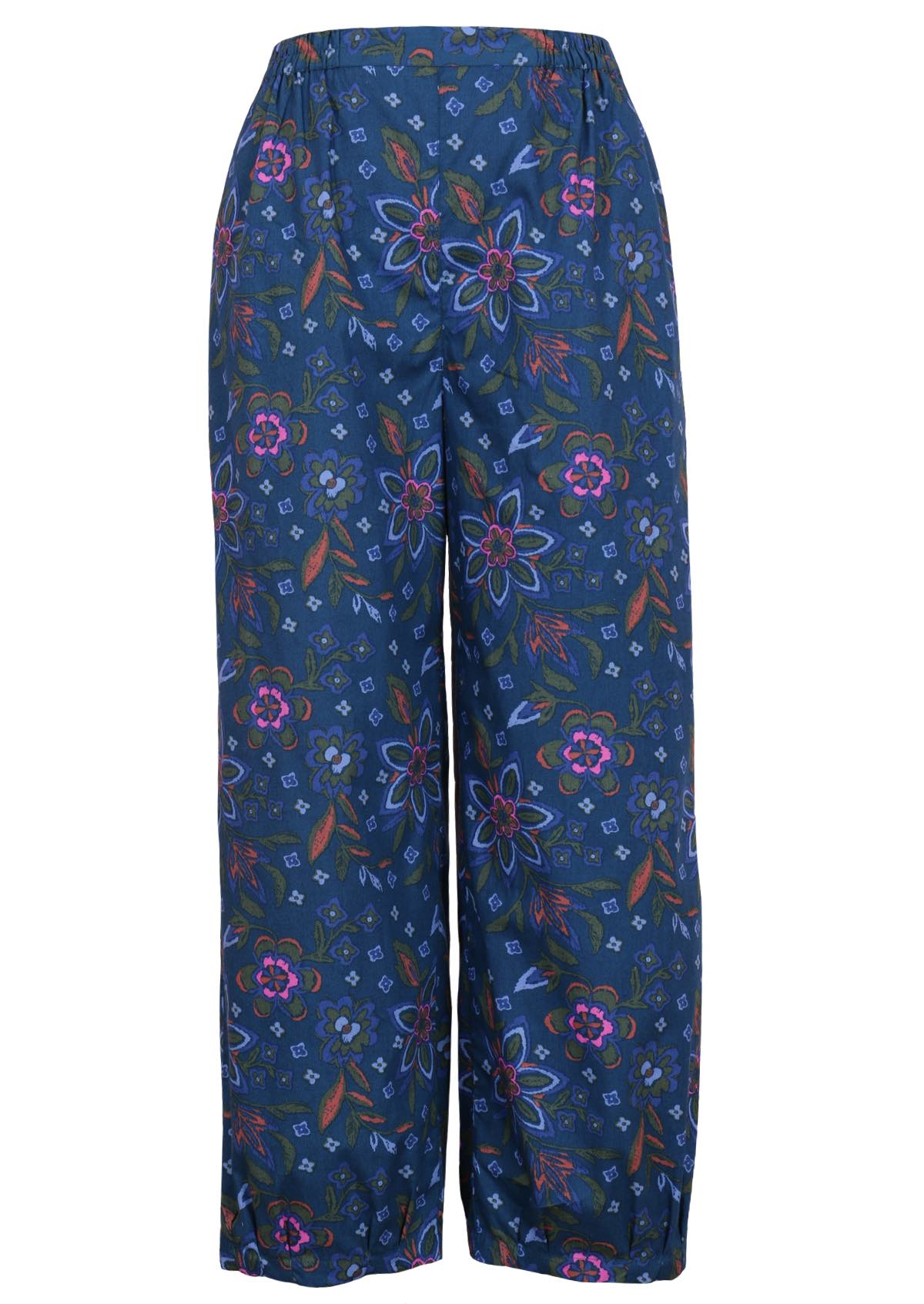 Floral cotton pants with a blue base have pleats at the ankles. 