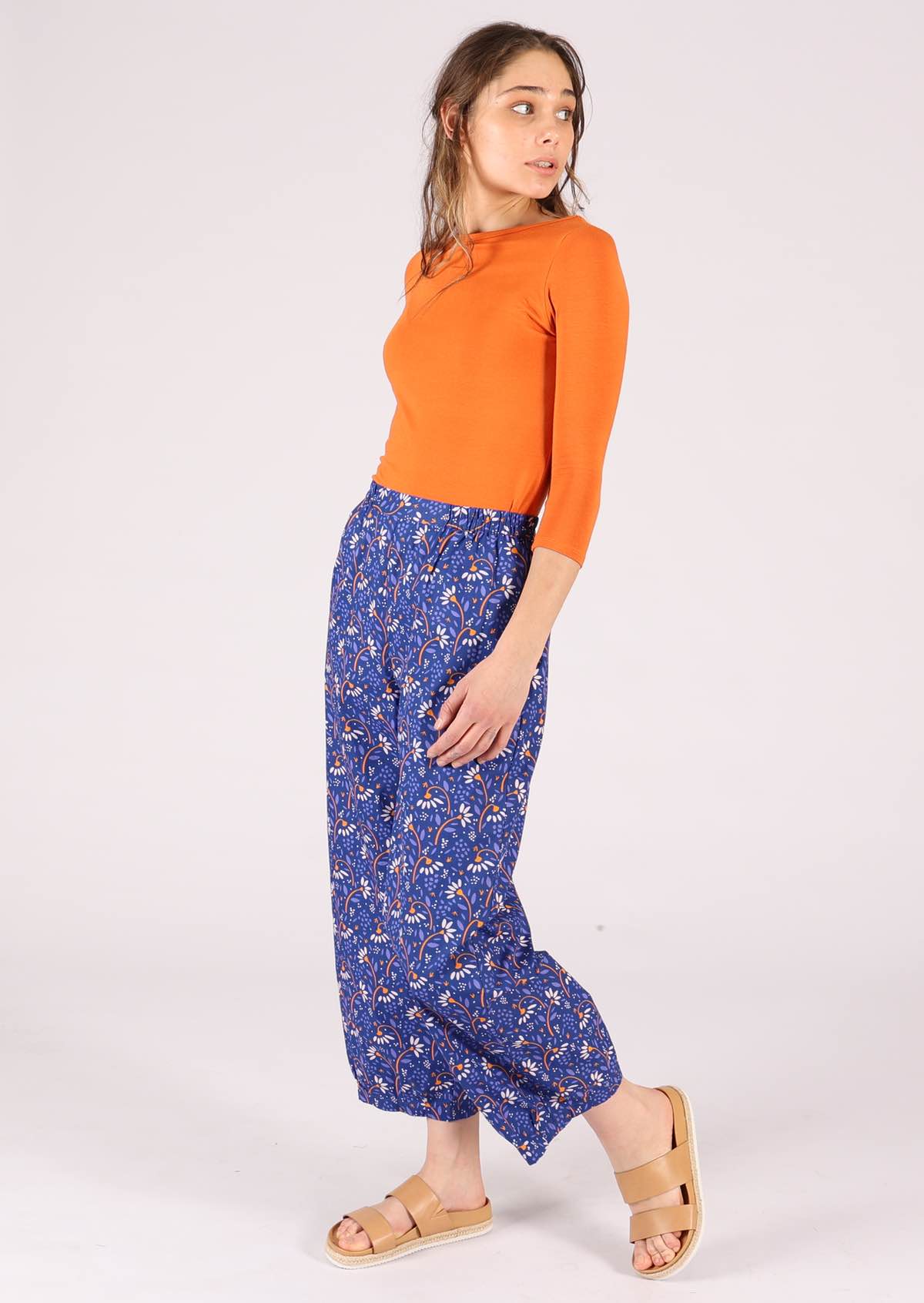 Fun orange and white daisy print on blue vivid base cotton pants