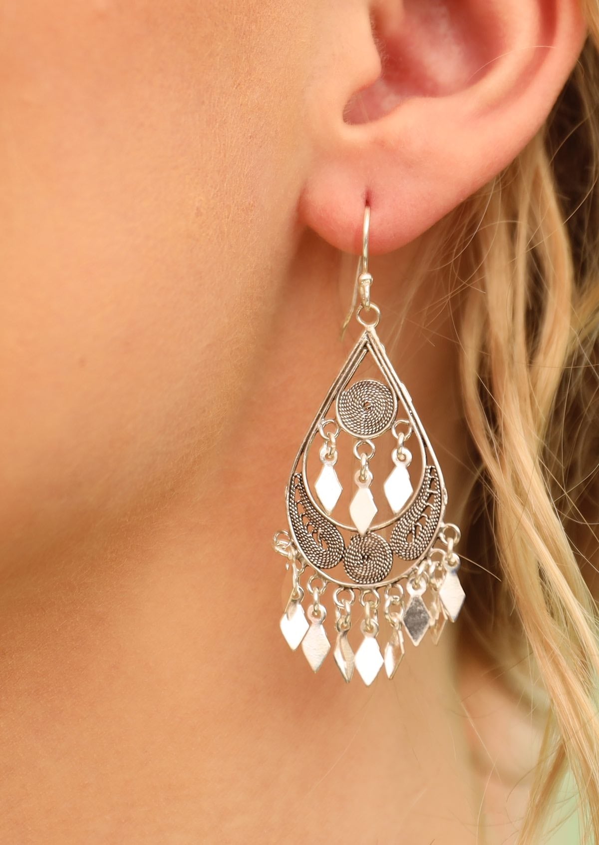 Close up of boho gypsy teardrop silver earring
