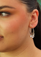 Gypsy boho silver earrings on woman with dark hair