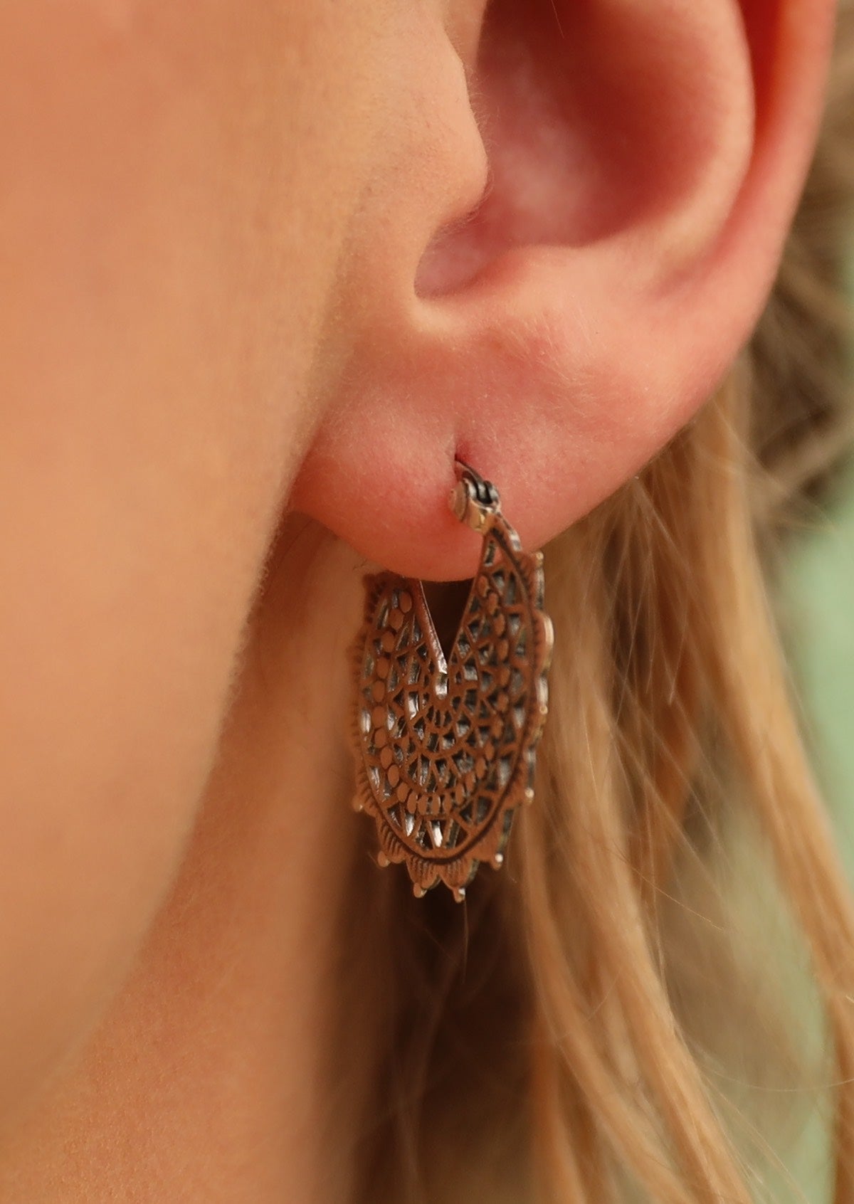 Close up of sterling silver lacy mandala earring