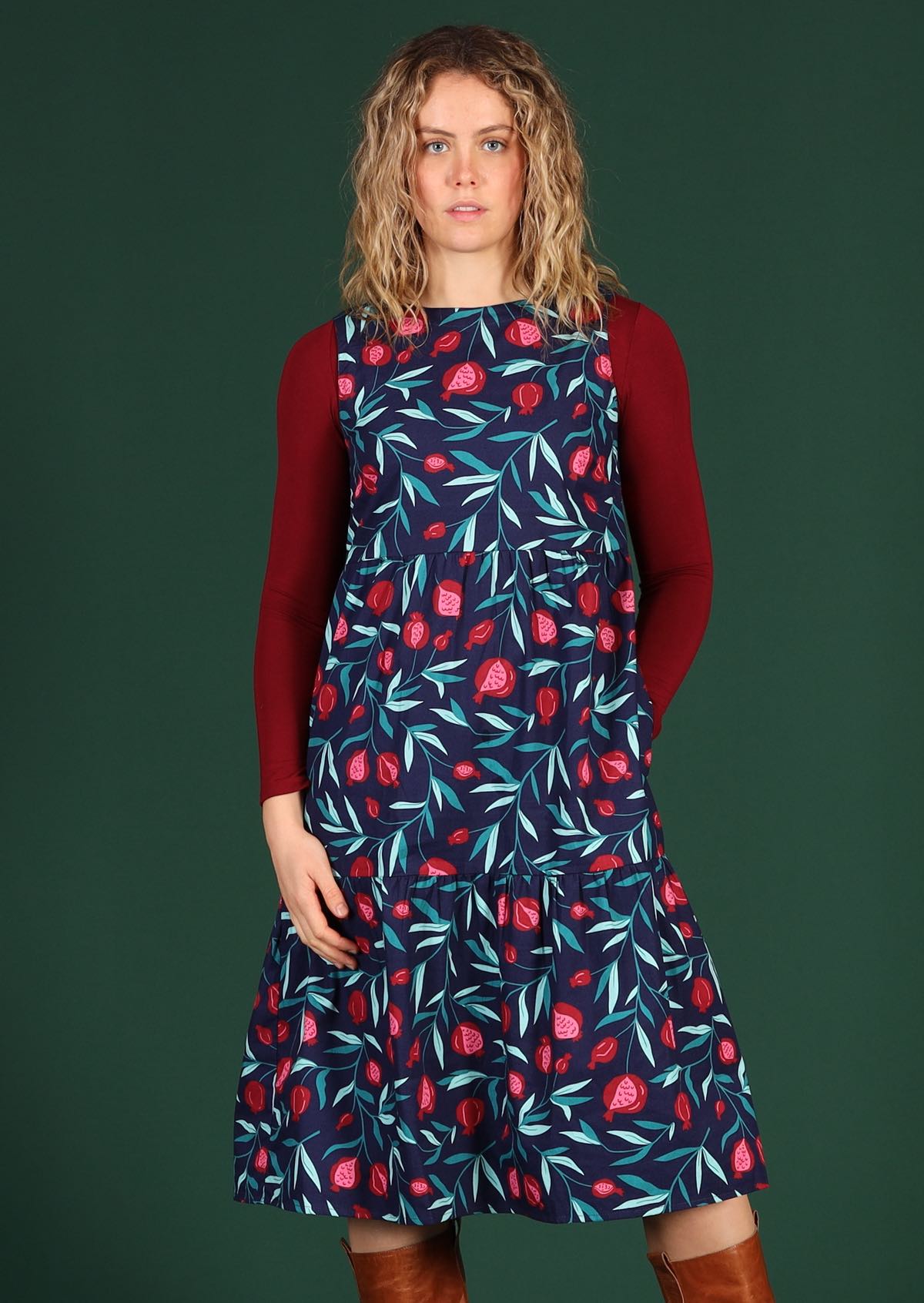Model wears below the knee blue fruit print dress.