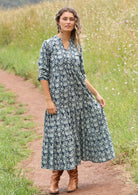 woman with hill in background wearing block print cotton maxi dress in navy blue