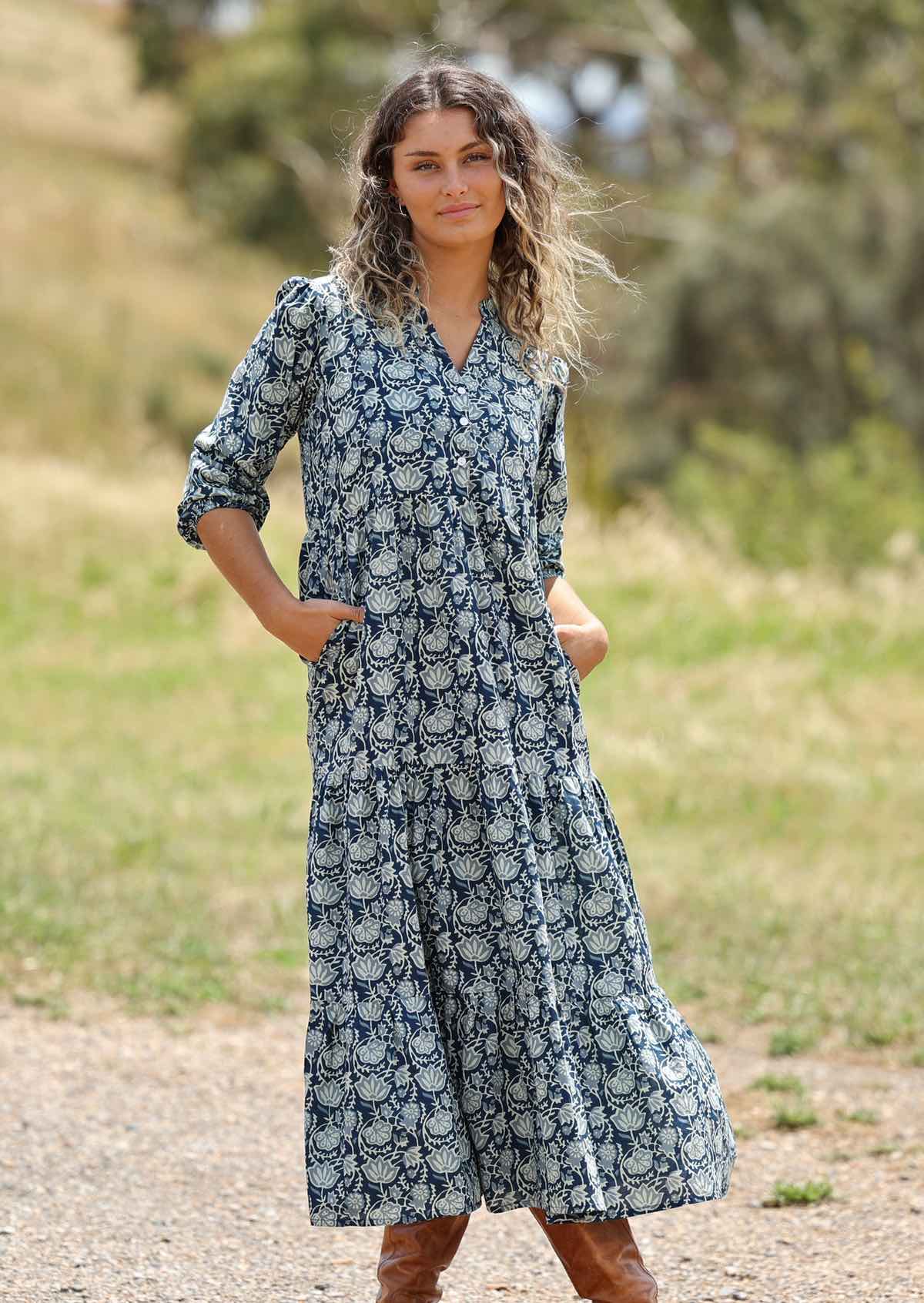 woman with hill in background wearing block print cotton maxi dress in Indigo print with hands in pockets