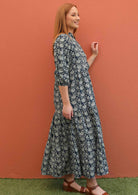 Model shows the side profile of her 100% cotton maxi dress. 