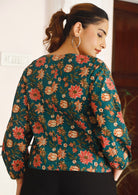 Model showing back of 100% cotton, loose fitting top with bishop sleeves and straight seam down the back