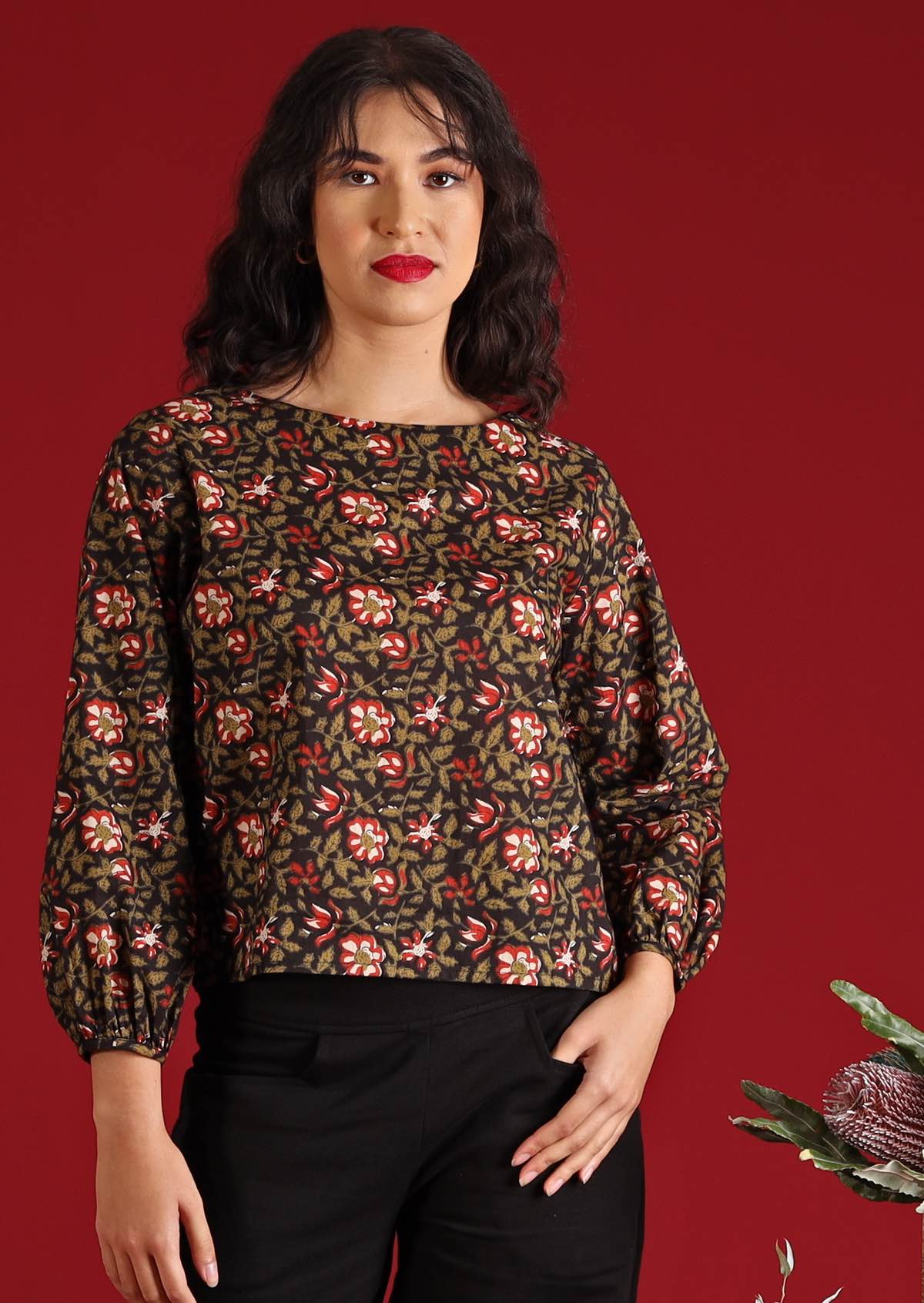 Model with dark hair and  in Isla Top Wild Rose black floral cotton boho top