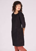 Dark grey corduroy dress that sits above the knee