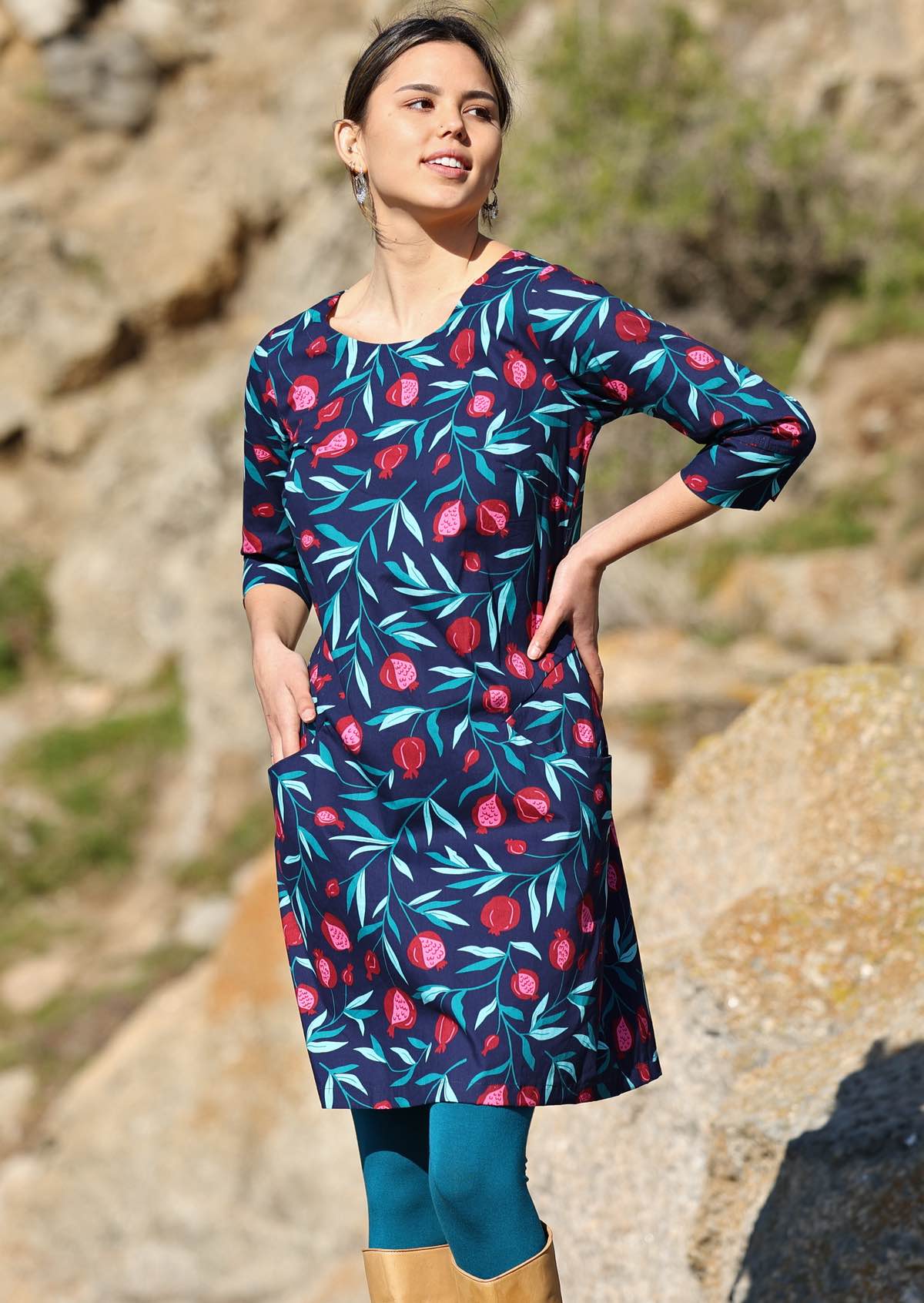Model wears blue base fruit print dress with 3/4 sleeves
