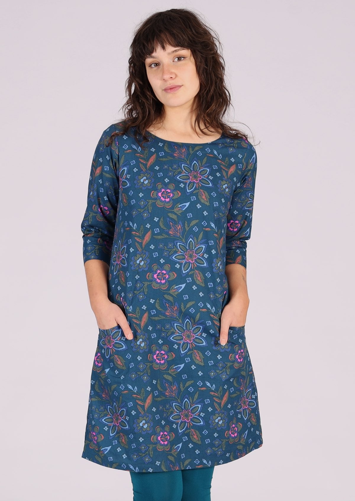 woman wearing navy floral long sleeve tunic dress