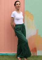 Smiling model wears 100% cotton pants with pockets. 