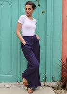 Model wears indigo coloured cotton pants. 