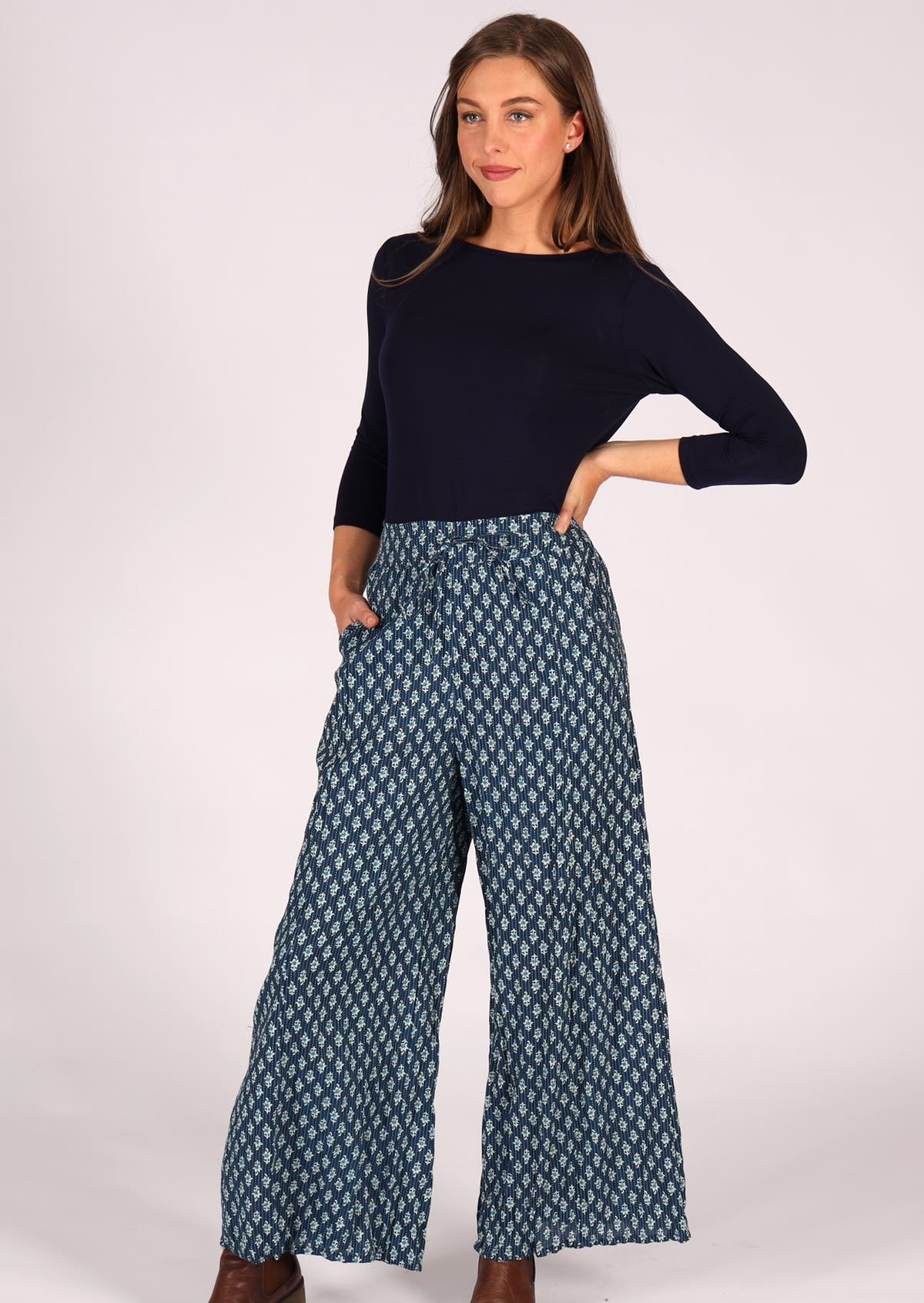 100% cotton floral wide leg pants are styled with a blue top. 