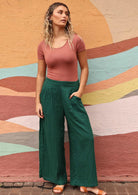 model standing casually with green Jaya pants