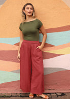 Model wears double cotton pants with pockets. 