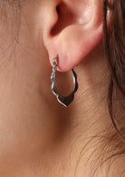 Sweet petal design to outer edge of these silver hoop earrings