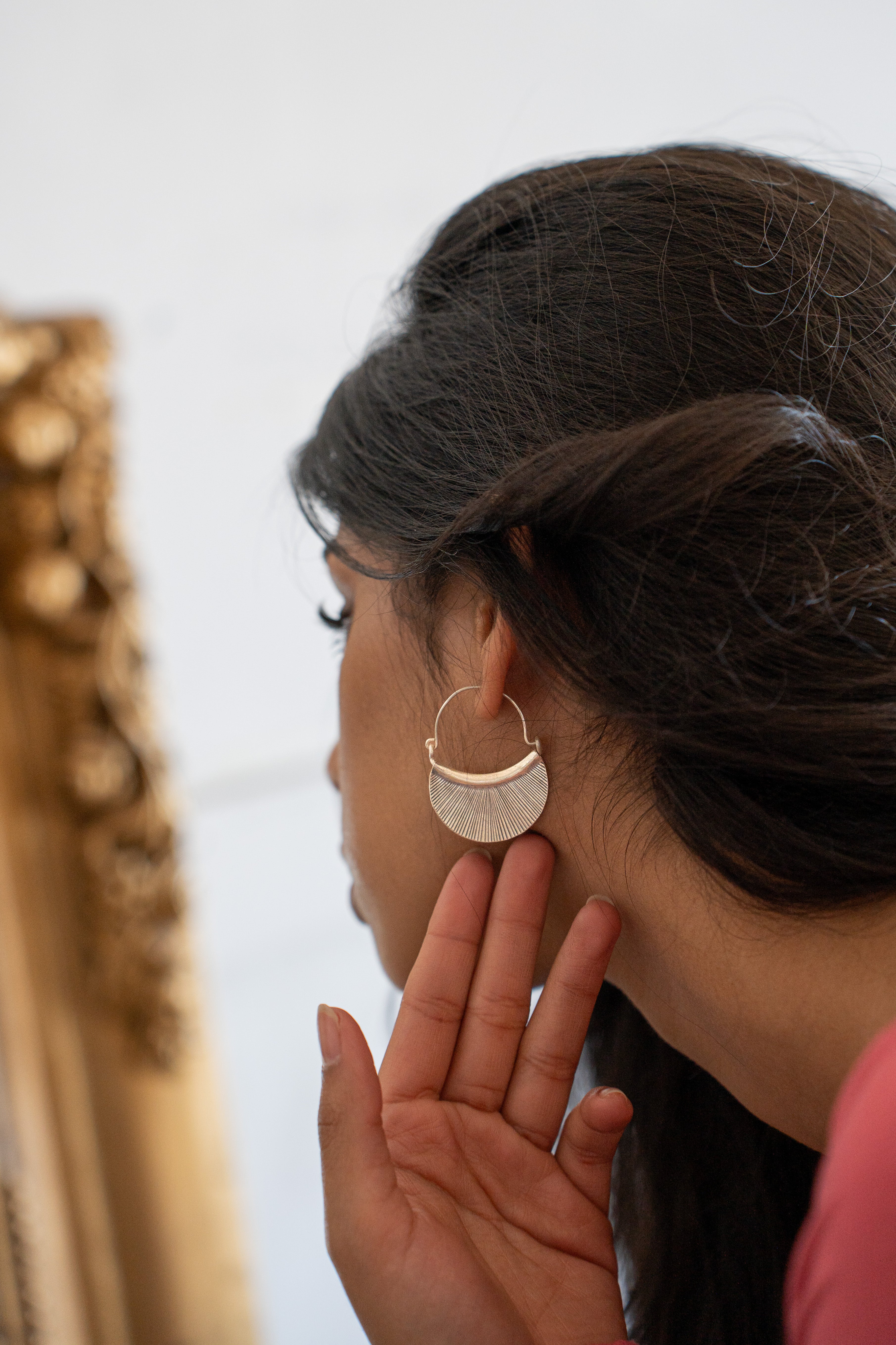 Woman wearing a Hill Tribe Silver hooped earring with a blurred background