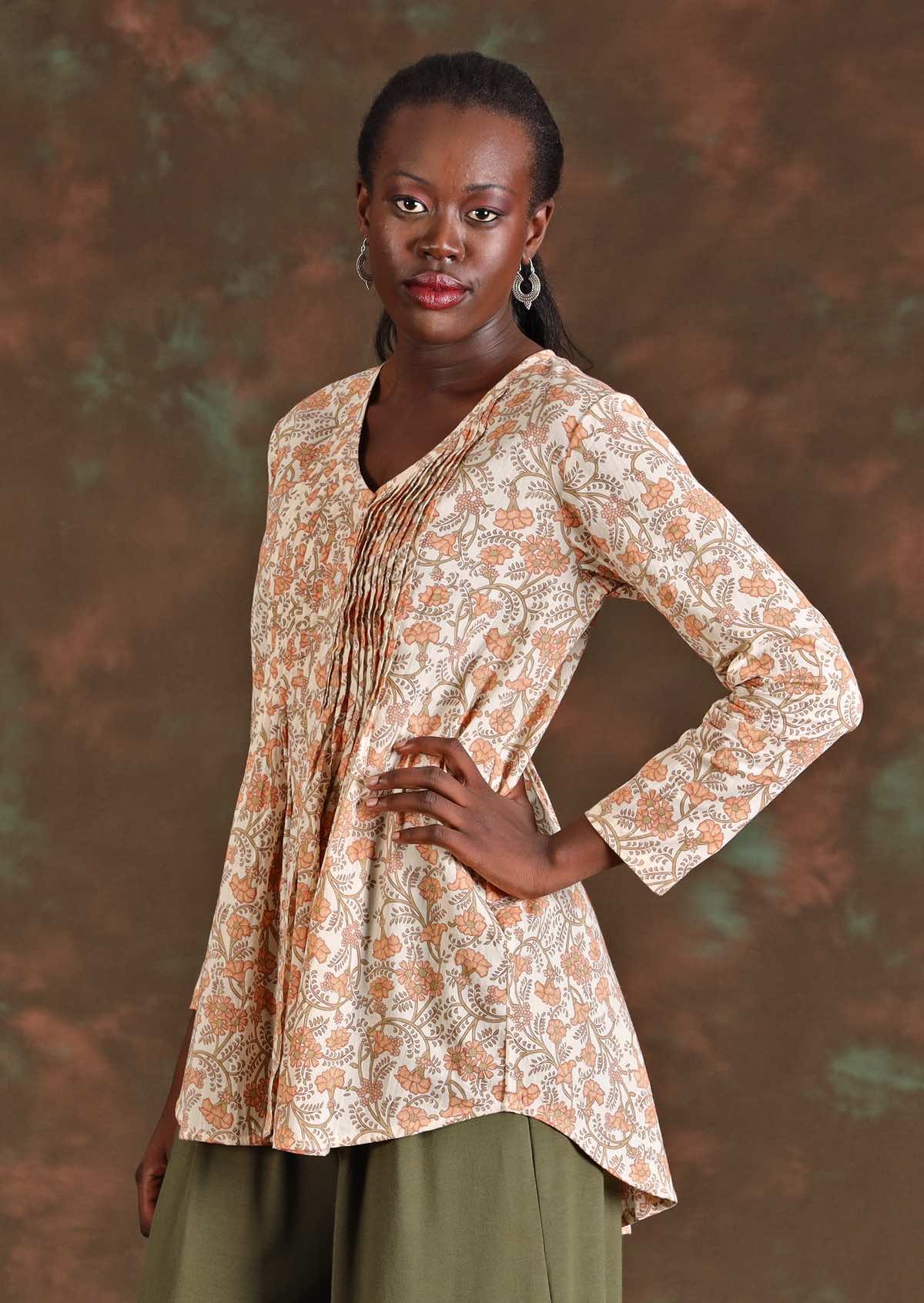 Side view of model on long sleeve floral cotton blouse