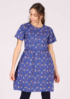 Model wears cotton daisy print dress with T-shirt sleeves
