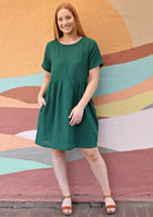model wearing short sleeve green dress