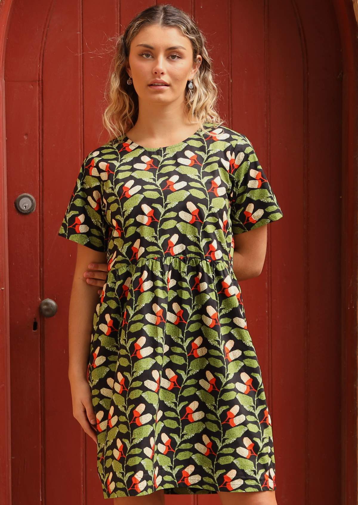 Model wearing 100 % cotton botanical print dress. 
