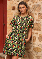 Model wearing relaxed fit acorn print dress with hands in pockets 