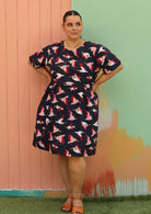woman wearing plus sized cotton dress navy blue with bird print