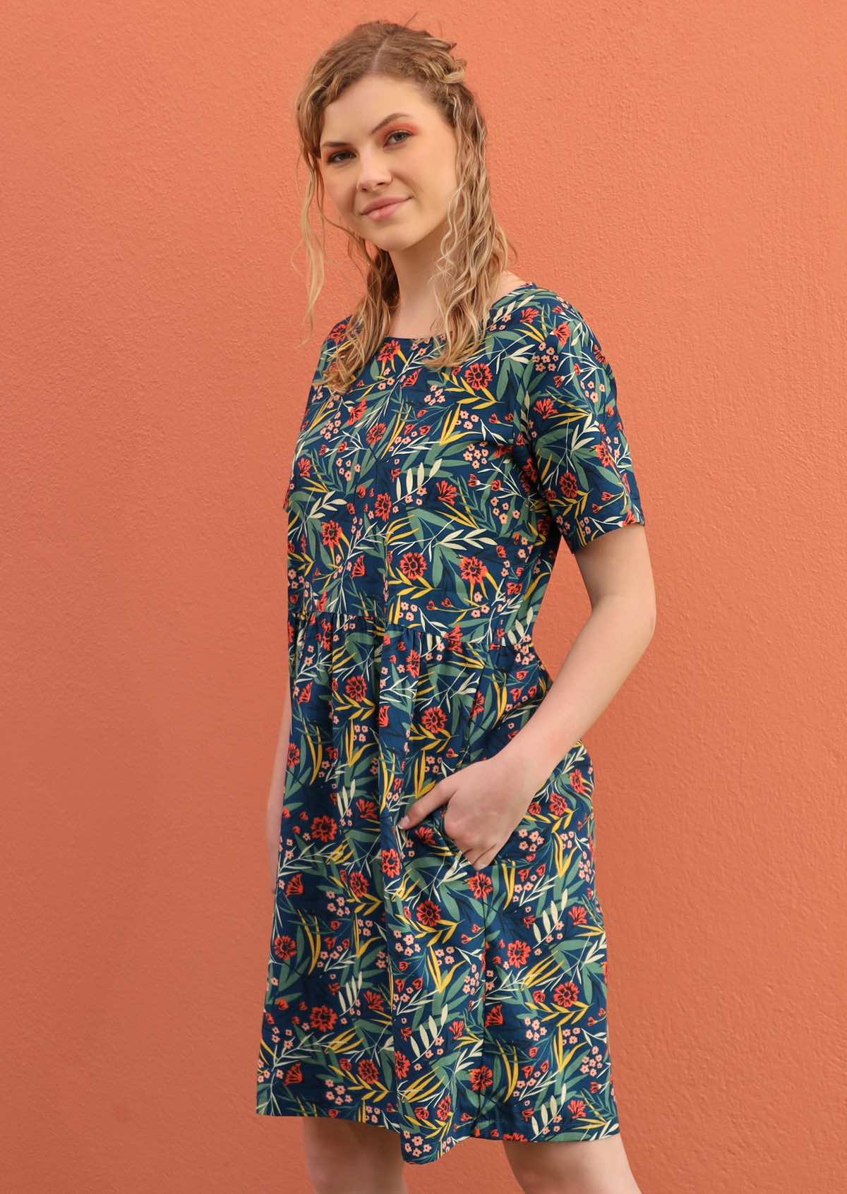 Model wears a 100% cotton dress that ends just above the knee. 