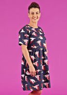 Model wearing short sleeve empire waistline relaxed fit dress