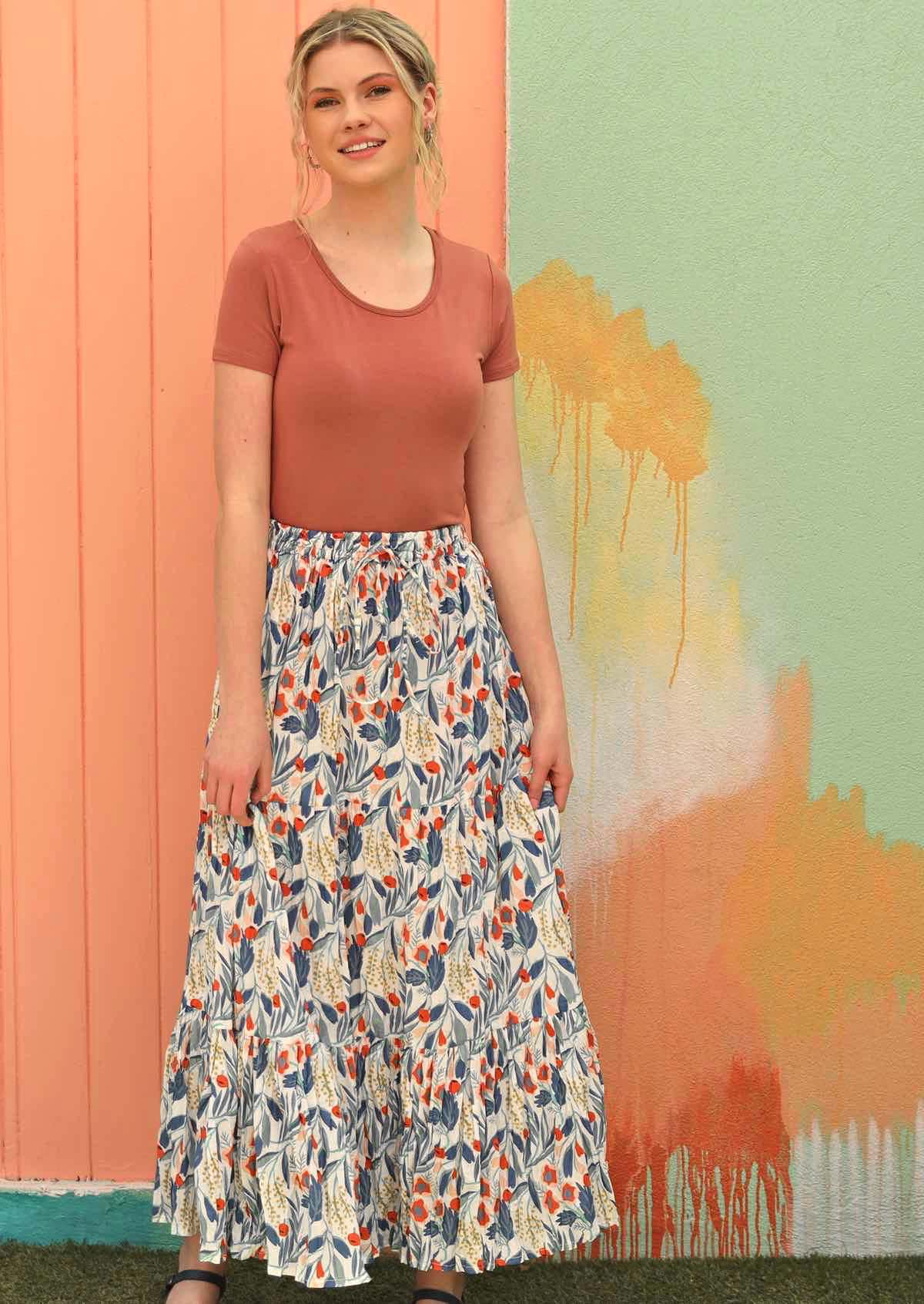 Model wears a 100% cotton maxi skirt styled with a short sleeve top and sandals. 