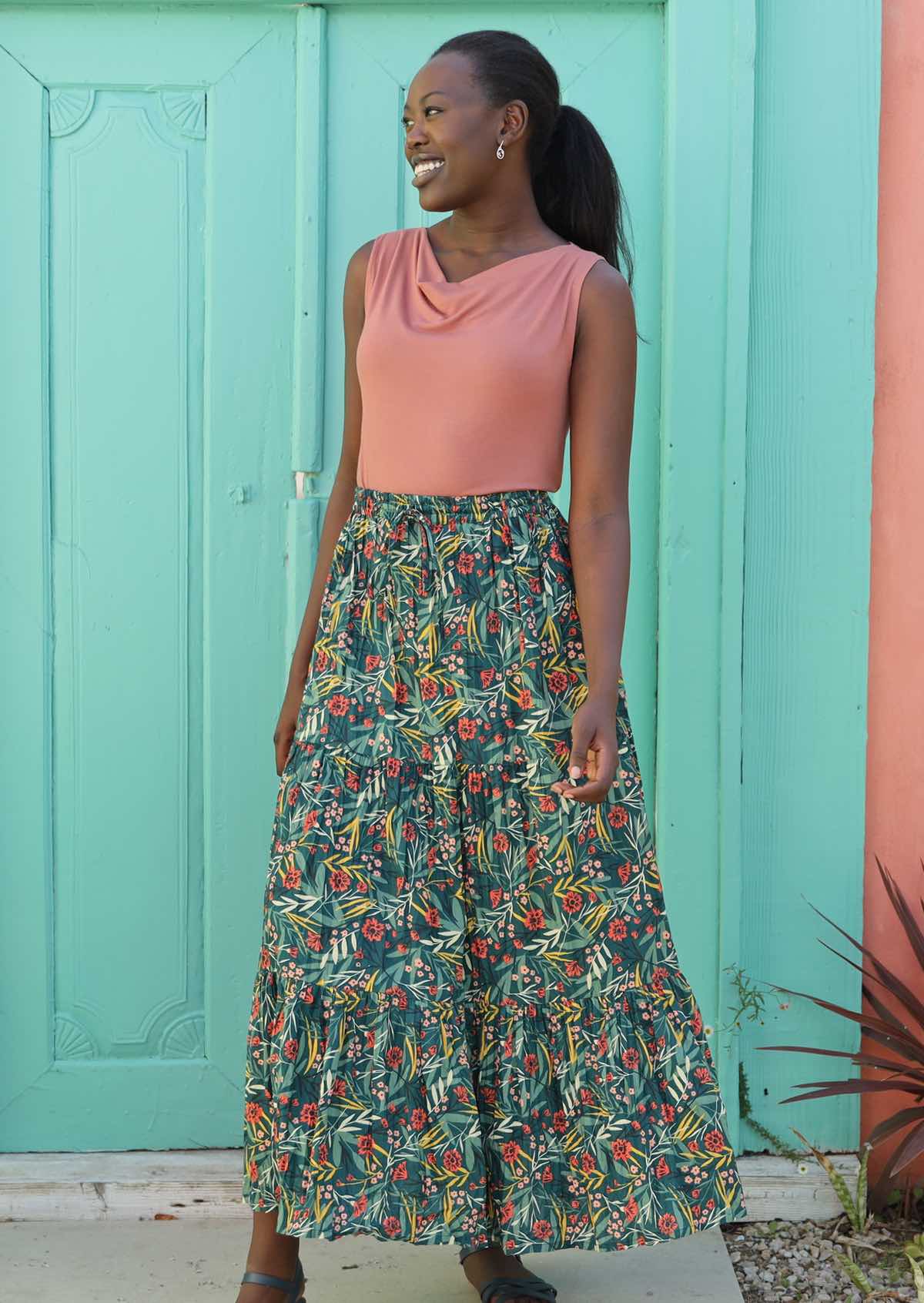 Model styles her maxi skirt with a sleeveless top and sandals. 