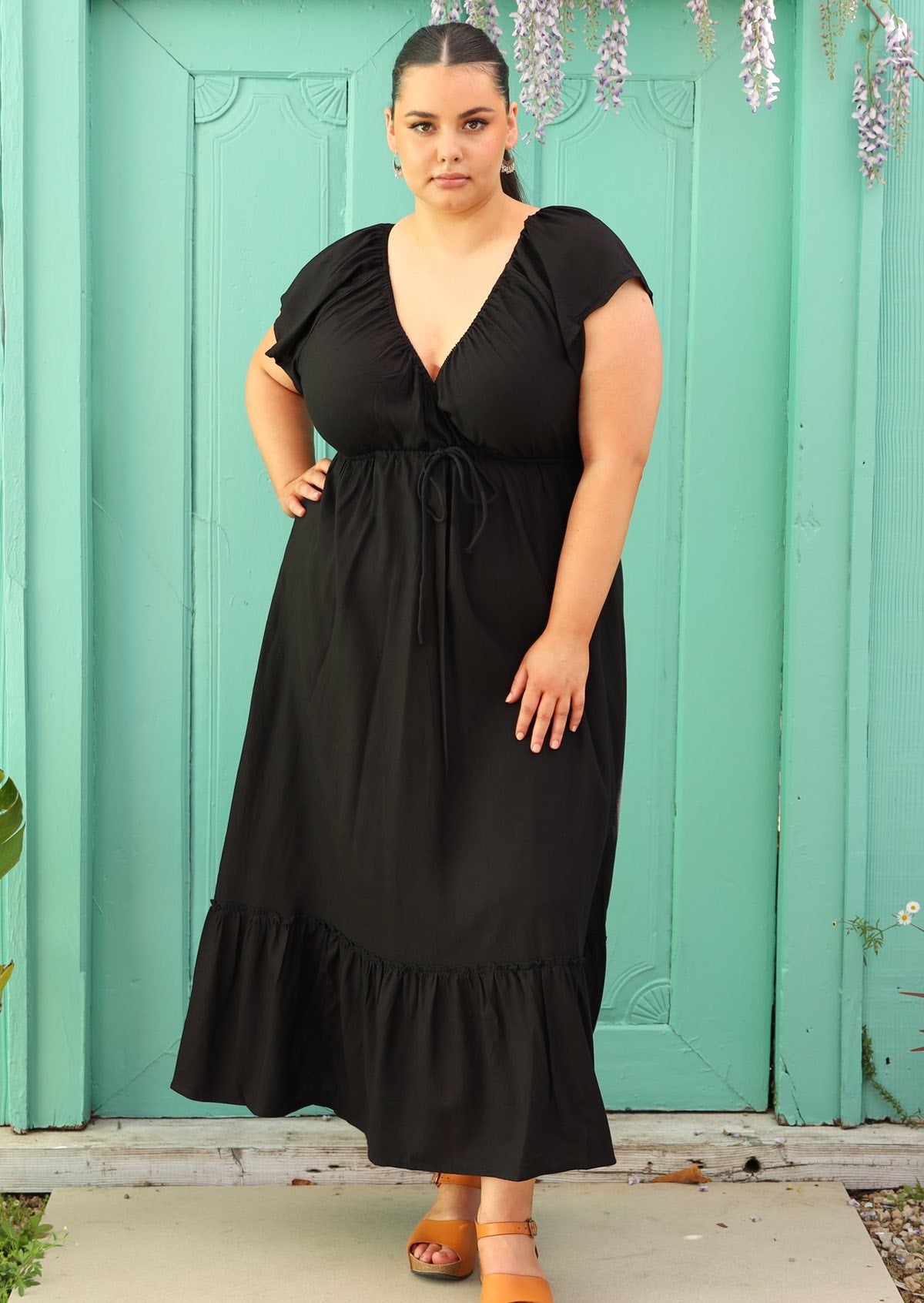 Curve sized woman wearing black maxi dress