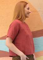 Model wears loose fitting double cotton top with short sleeves.