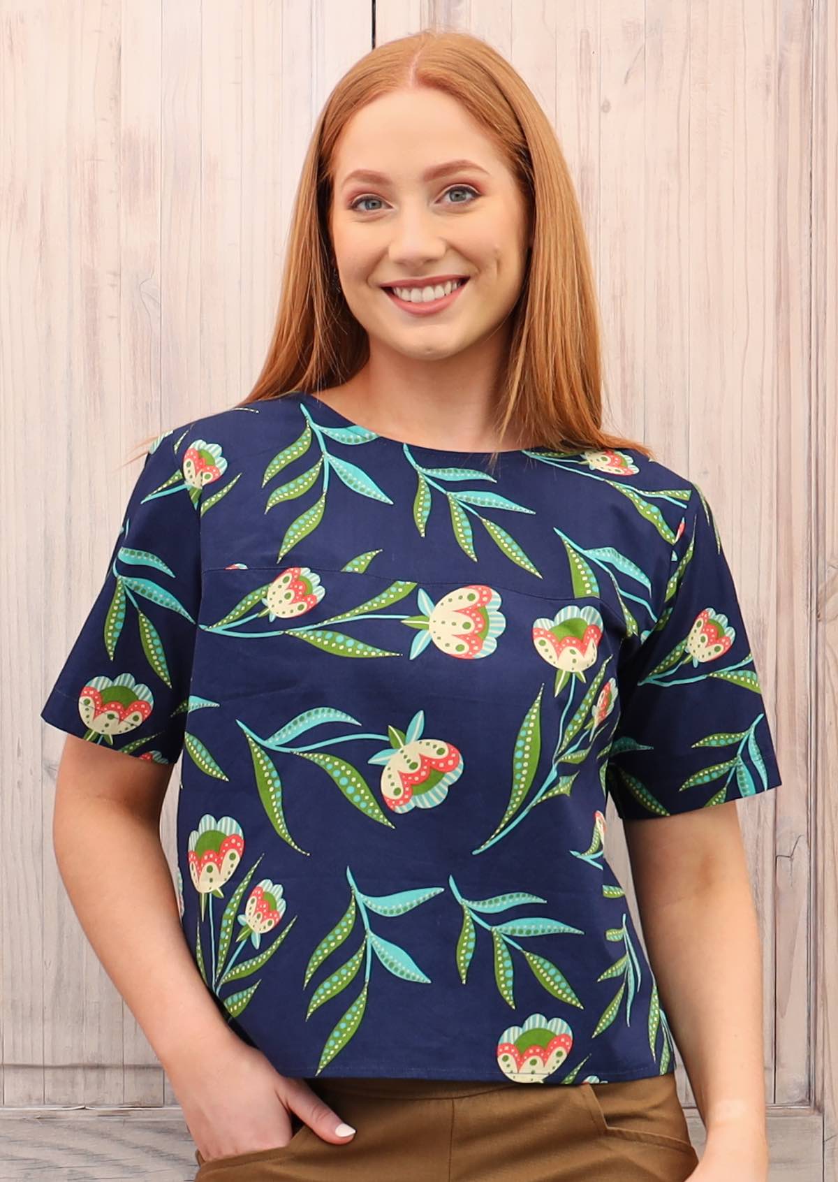 Model smiles in floral cotton relaxed fit top with T-shirt sleeves