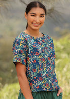 Model smiles in cotton floral print relaxed fit short sleeve cottontop