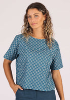 Model wears cotton top with T-shirt sleeves and high round neck