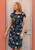 Model wears flattering cotton floral dress with cap sleeves