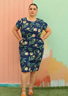 Plus size model wearing flattering cotton dress in blue with pockets