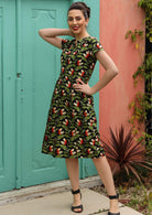 Model wears over knee length cotton dress with A-line skirt